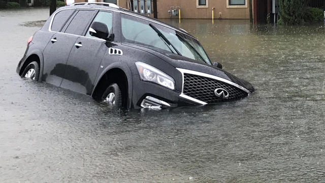 A vehicle sits half submerged in flood waters in a residential area in the aftermath of Hurricane Harvey in Houston 