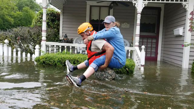 Handout photo of a Texas National Guard soldier carries a woman on his bank as they conduct rescue operations in flooded areas around Houston 