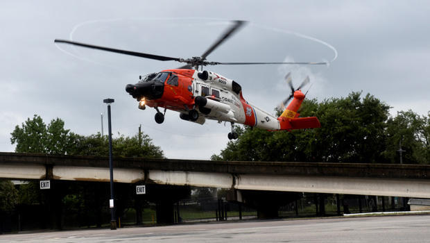 A U.S. Coast Guard helicopter carrying evacuees comes in for a landing near the George R. Brown Convention Center after Hurricane Harvey inundated the Texas Gulf coast with rain causing widespread flooding, in Houston 