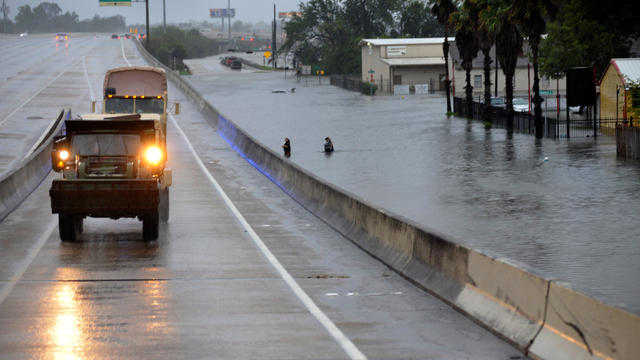 Rescue vehicles drive past flooding on Interstate 610 after Hurricane Harvey inundated the Texas Gulf coast with rain causing widespread flooding, in Houston 