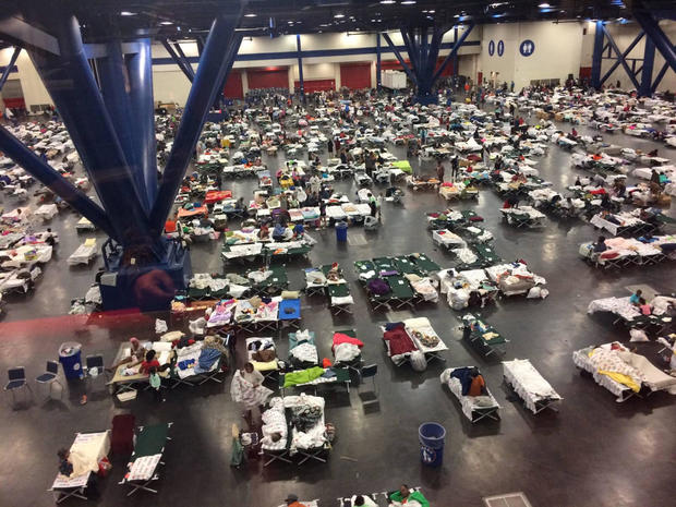 Evacuees take shelter from Tropical Storm Harvey in the George R. Brown Convention Center in Houston, Texas, U.S. in this handout photo 