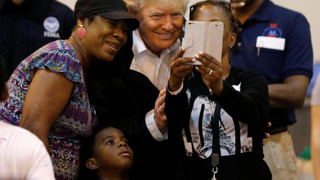 U.S. President Donald Trump poses for a photo with a family at a Hurricane Relief Center where he met with flood survivors of Hurricane Harvey, in Houston 