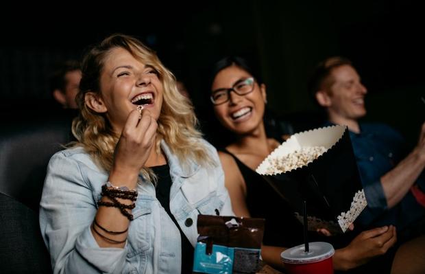 moviegoers eating popcorn 