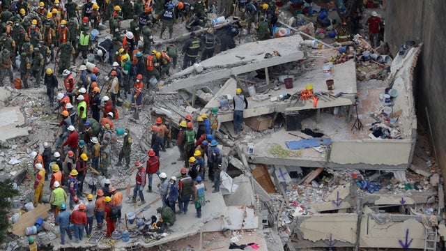 Rescuers and people work at a collapsed building after an earthquake hit Mexico City, Mexico 