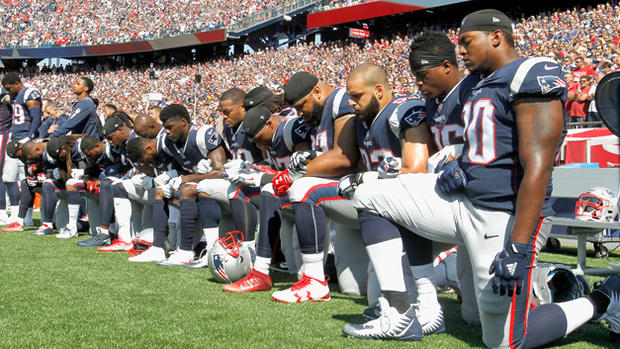Patriots players take a knee during the national anthem 