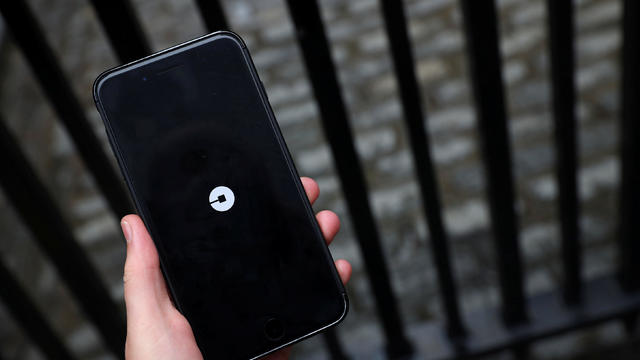 The Uber logo is seen on mobile telephone in London 