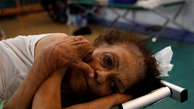 Hilda Colon wakes up after sleeping in a shelter set up at the Pedrin Zorrilla coliseum after the area was hit by Hurricane Maria in San Juan, Puerto Rico, Sept. 25, 2017. 