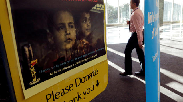 A man walks near a box for donations to Syrian refugees during the 72nd United Nations General Assembly at U.N. headquarters in New York 