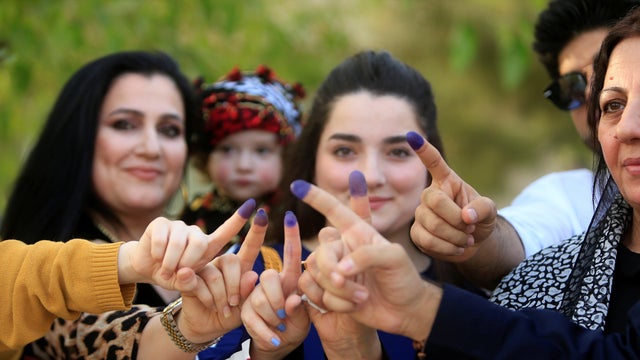 Women show their ink-stained fingers during the Kurds' independence referendum in Sulaimaniyah, Iraq, Sept. 25, 2017. 