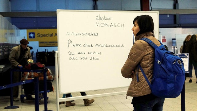Signs inform passengers of Monarch flight cancellations after the airline ceased trading, at Luton airport, Britain 
