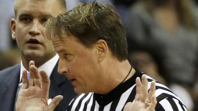 Kentucky head coach John Calipari, unseen, argues a call with referee John Higgins in the first half of the South Regional final game against North Carolina in the NCAA college basketball tournament in Memphis, Tenn., March 26, 2017. 