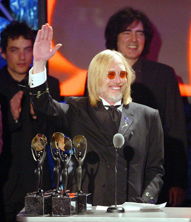 Inductee Tom Petty waves as he and his band The He 