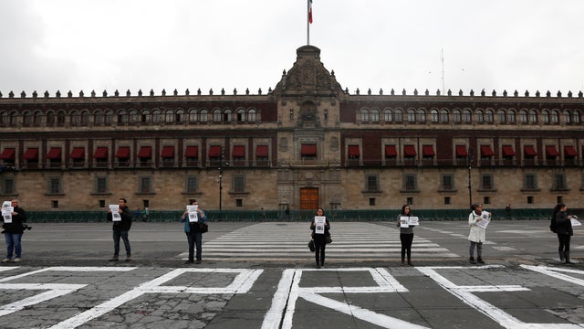 A group of journalist hold placards during a protest outside the National Palace for the slain journalist Salvador Adame in Mexico City 