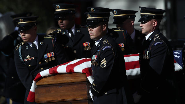 A burial team carries the casket of U.S. Army Staff Sgt. James F. Moriarty during the soldier's burial service at Arlington National Cemetery Dec. 5, 2016, in Arlington, Virginia. 