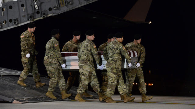 A U.S. Army carry team transfers the remains of Army Staff Sgt. Dustin Wright at Dover Air Force Base in Delaware 