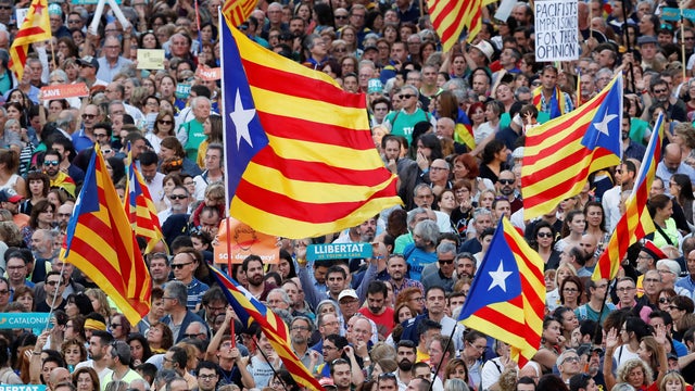 People wave Catalan separatist flags during a demonstration organised by Catalan pro-independence movements ANC (Catalan National Assembly) and Omnium Cutural, following the imprisonment of their two leaders Jordi Sanchez and Jordi Cuixart, in Barcelona 