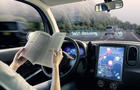 cockpit of autonomous car. a vehicle running self driving mode and a woman driver reading book. 