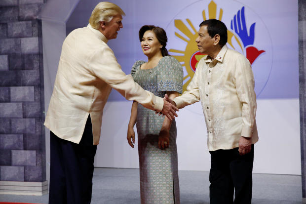 U.S. President Donald Trump shakes hands with Philippines President Rodrigo Duterte as he arrives for the gala dinner marking ASEAN's 50th anniversary in Manila 