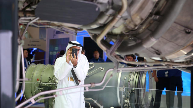 A visitor takes a photo of an aircraft engine at the Dubai Air Show in Dubai 