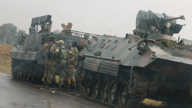 Soldiers stand beside military vehicles just outside Harare,Zimbabwe 