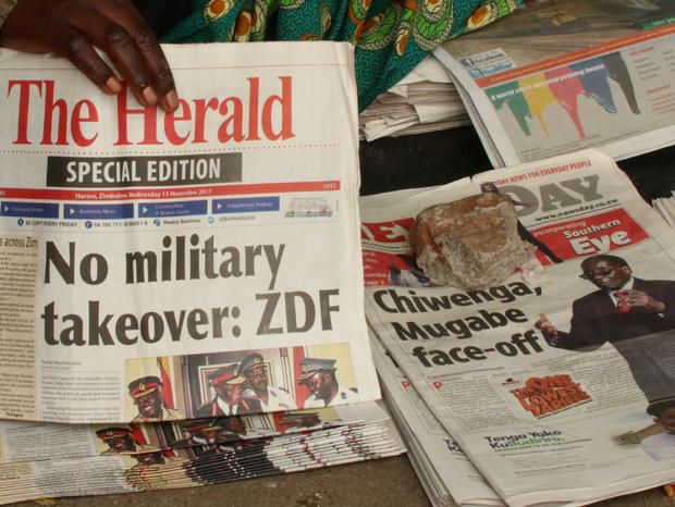A vendor picks up a copy of a special edition of the state-owned daily newspaper The Herald in Harare 