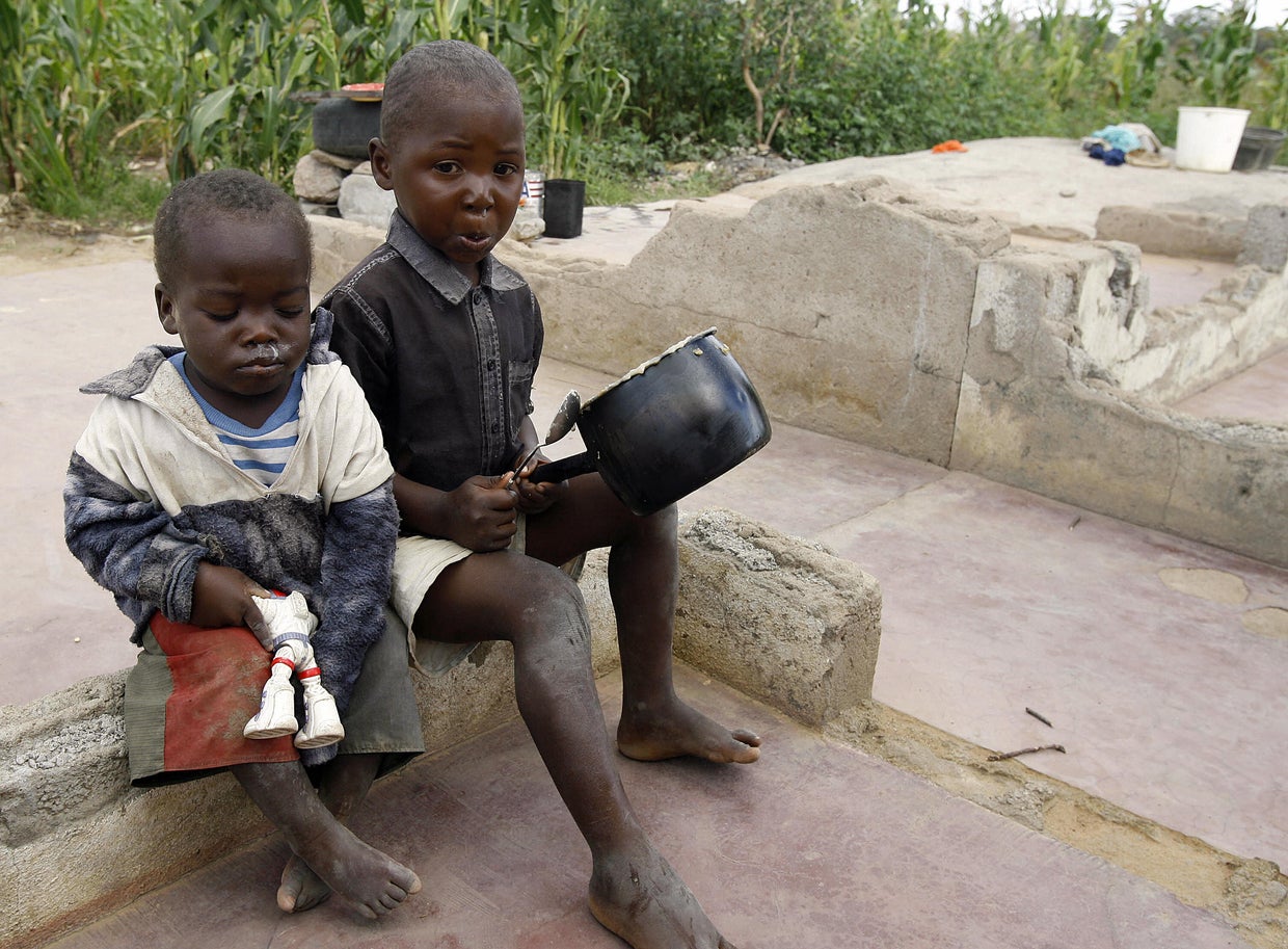 A four-year-old girl scrapes food from a 