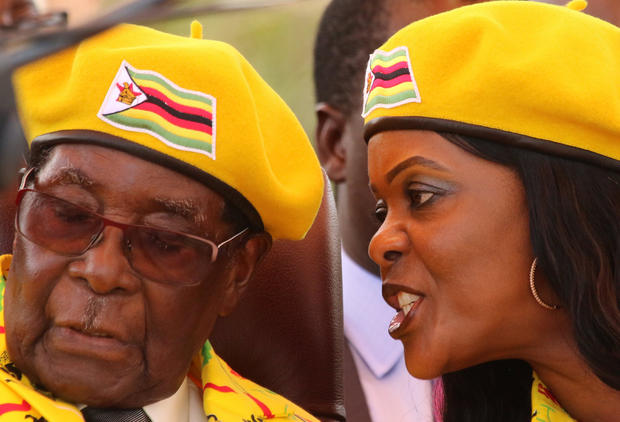 FILE PHOTO: President Robert Mugabe listens to his wife Grace Mugabe at a rally of his ruling ZANU(PF) party in Harare 
