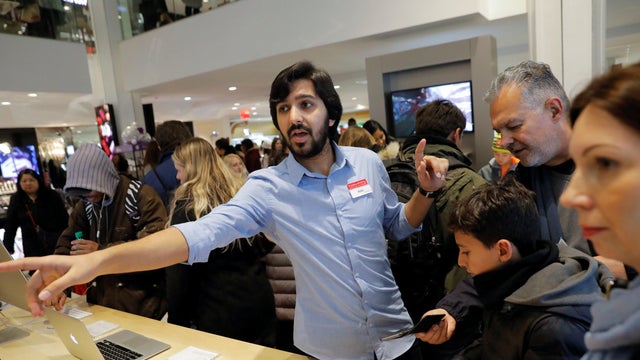 A sales attendant works in the Apple concession at Macy's Herald Square during early opening for the Black Friday sales in Manhattan 
