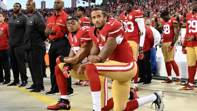 Colin Kaepernick, center, and Eric Reid of the San Francisco 49ers kneel in protest during the national anthem prior to playing the Los Angeles Rams in their NFL game at Levi's Stadium on Sept. 12, 2016, in Santa Clara, California. 