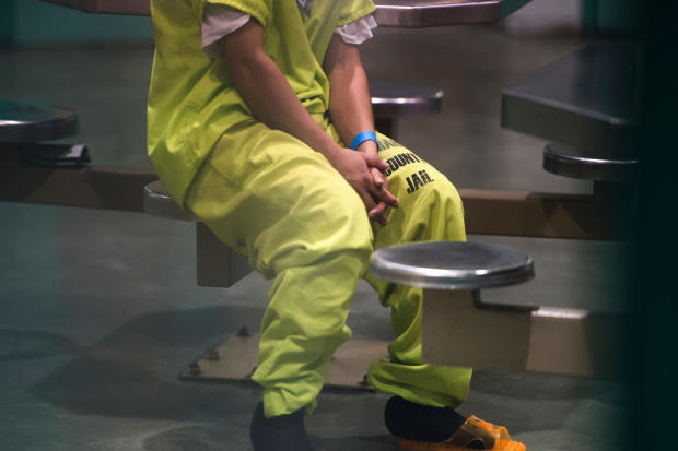 An immigration detainee sits in a high-security unit at the Theo Lacy Facility, a county jail which also houses immigration detainees arrested by the U.S. Immigration and Customs Enforcement agency, in Orange, California, about 32 miles southeast of Los A 