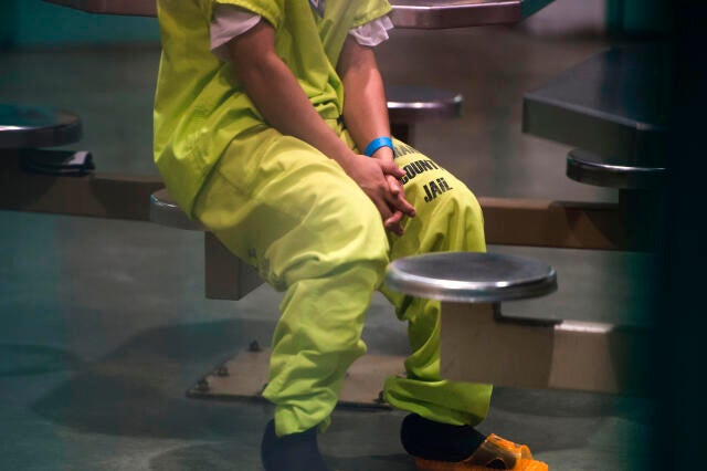 An immigration detainee sits in a high-security unit at the Theo Lacy Facility, a county jail which also houses immigration detainees arrested by the U.S. Immigration and Customs Enforcement agency, in Orange, California, about 32 miles southeast of Los A 