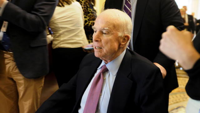 U.S. Senator John McCain (R-AZ) leaves the Senate floor in a wheelchair during debate over the Republican tax reform plan in Washington 