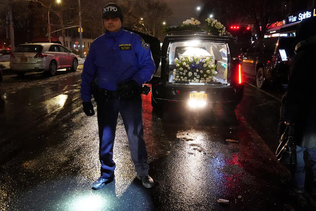A New York Police Department officer stands guard over the hearse that bears the casket of Erica Garner following her funeral in the Harlem borough of New York City 