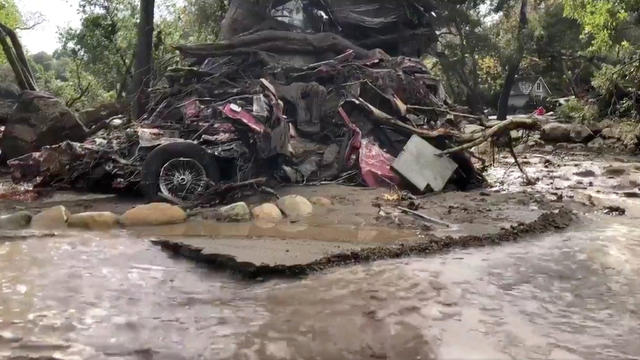 A vehicle is wrapped around a tree after flood and mudslides in Montecito 