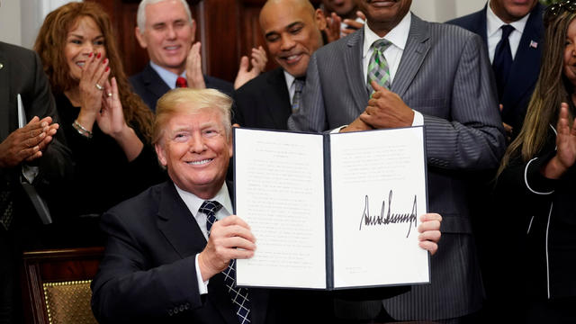 U.S. President Donald Trump holds up a proclamation to honoring Martin Luther King Jr. in the Roosevelt Room of the White House in Washington 