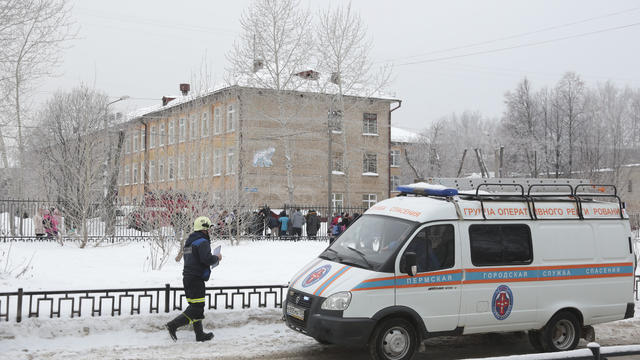 A vehicle of the Russian Emergencies Ministry is parked near a local school after reportedly several unidentified people wearing masks injured schoolchildren with knives in Perm 