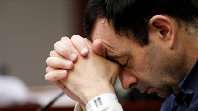 Dr. Larry Nassar, a former USA Gymnastics team doctor who pleaded guilty in November 2017 to sexual assault charges, listens to a victim during his sentencing hearing in Lansing, Michigan, Jan. 16, 2018. 