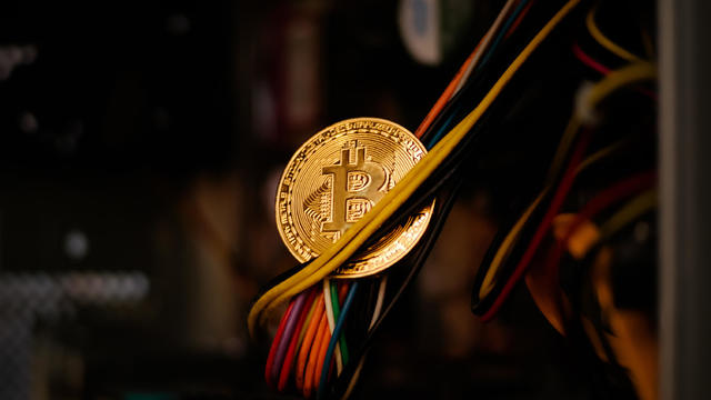 holding golden Bitcoin 