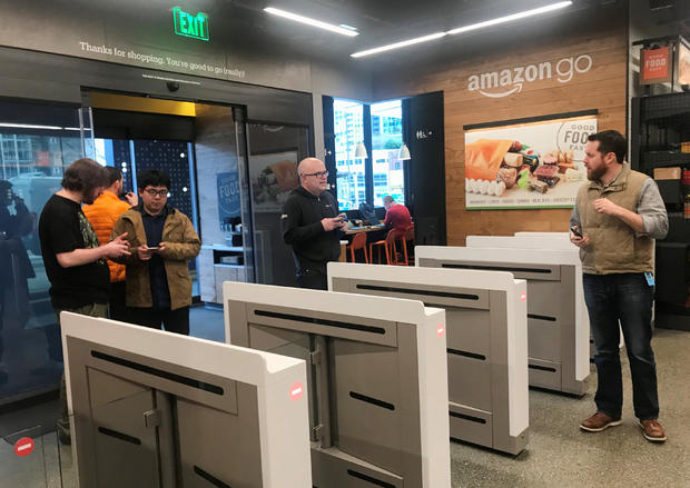 Shoppers enter the Amazon Go store located in Amazon's "Day 1" office building in Seattle 