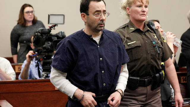 Larry Nassar, a former team USA Gymnastics doctor, who pleaded guilty in November 2017 to sexual assault charges, is led from the courtroom after listening to victim testimony during his sentencing hearing in Lansing, Michigan 