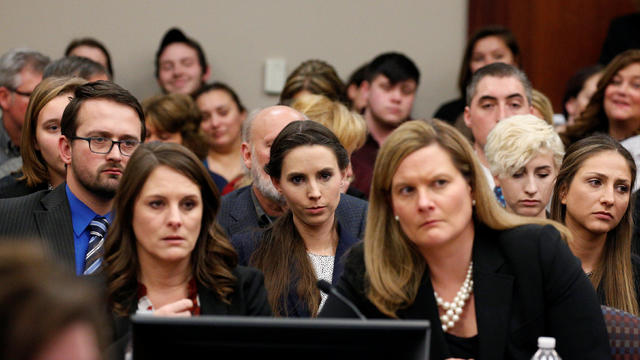 Victim Rachael Denhollander listens as Larry Nassar, a former team USA Gymnastics doctor who pleaded guilty in November 2017 to sexual assault charges, is sentenced in Lansing 