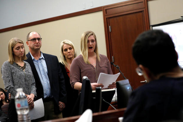 Victims and former gymnasts Maddie and Kara Johnson speak alongside their parents Brad and Kelly Johnson at the sentencing hearing for Larry Nassar, in Lansing 
