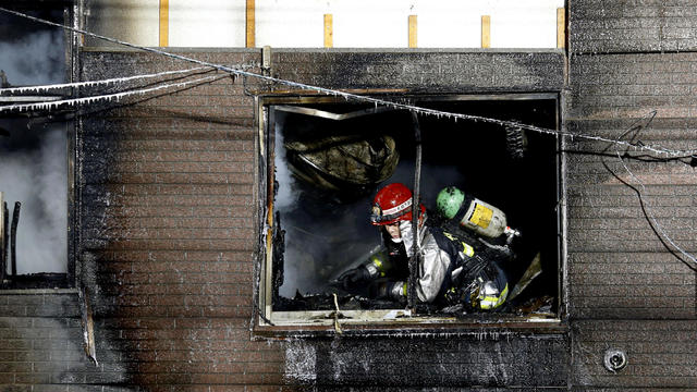 A firefighter inspects a facility to support senior people on welfare, where a fire occurred, in Sapporo 