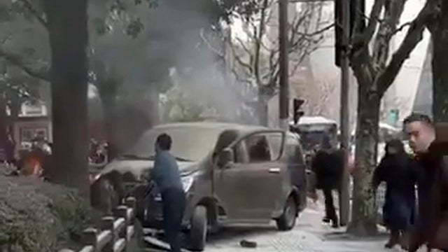 FILE PHOTO: A Chinese flag is seen in front of the financial district of Pudong in Shanghai 