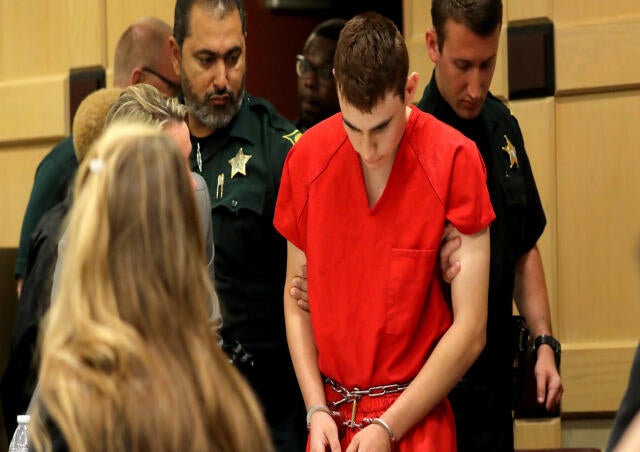 Nikolas Cruz, facing 17 charges of premeditated murder in the mass shooting at Marjory Stoneman Douglas High School in Parkland, Florida, appears in court for a status hearing before Broward Circuit Judge Elizabeth Scherer in Fort Lauderdale Feb. 19, 2018 