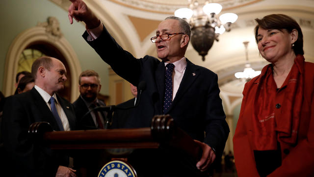 Senate Minority Leader Chuck Schumer, accompanied by Sen. Chris Coons (D-DE) and Sen. Amy Klobuchar (D-MN), speaks with reporters following the weekly policy luncheons at the U.S. Capitol in Washington 