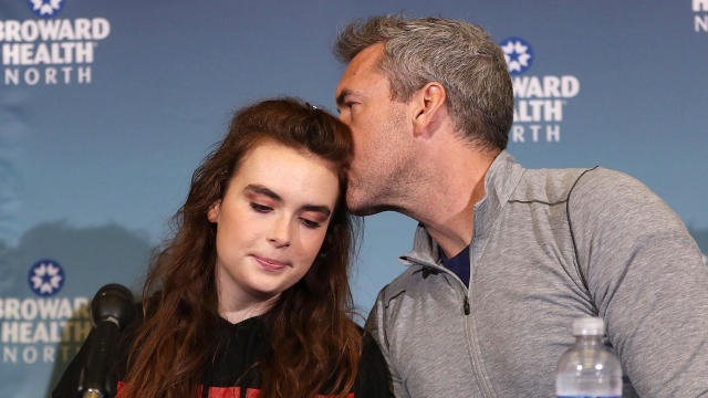 David Wilford kisses his daughter, Maddy Wilford, after she spoke to the media at Broward Health North after being shot multiple times during the mass shooting at Marjory Stoneman Douglas High School, where she is a student, on Feb. 26, 2018, in Deerfield Beach, Florida. 