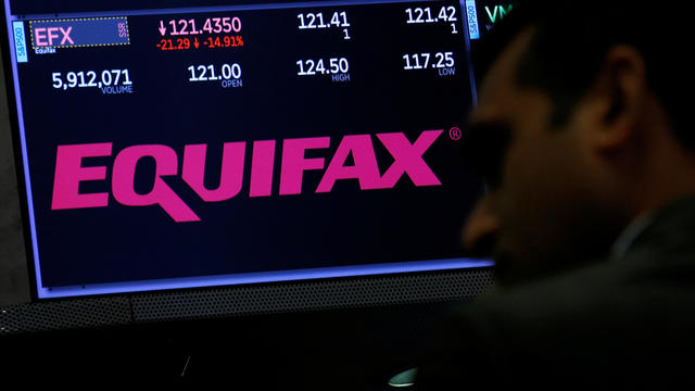 Trading information and the company logo are displayed on a screen where the stock is traded on the floor of the NYSE in New York 