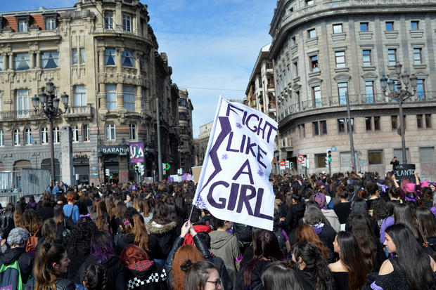 A protester holds a banner reading "Fight Like A Girl" during a demonstration for women's rights on International Women's Day in Bilbao 