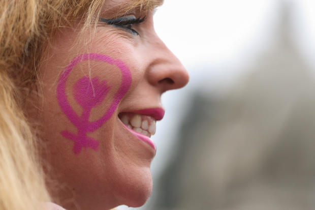 Woman smiles at nationwide feminist strike on IWD at Cibeles Square in Madrid 